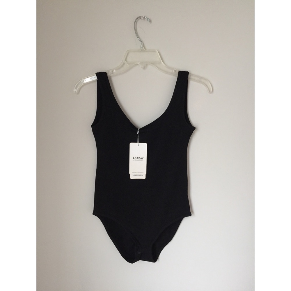 NWT solid black body suit, size M.